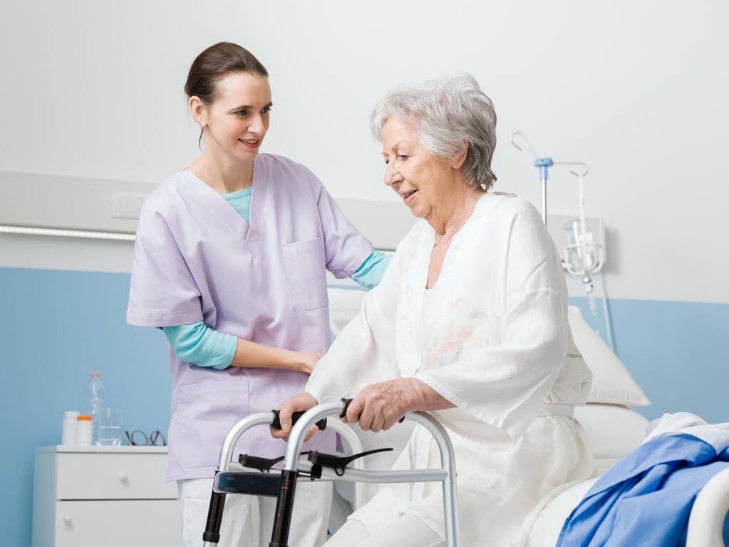 A care professional assisting an older patient